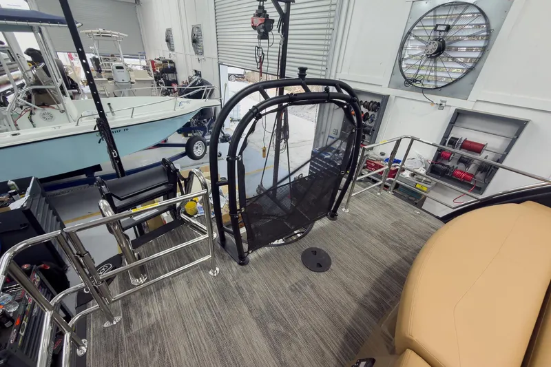 Slide: The Image of 2026 Godfrey Sanpan 25' Tritoon interior with co-captain seating and marine equipment. - 46