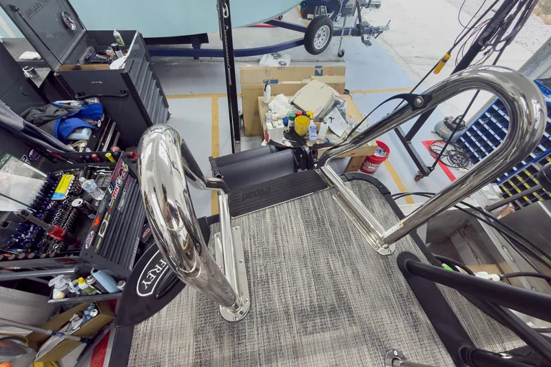 Slide: The Image of Workshop view of a 2026 Godfrey Sanpan 25' Tritoon assembly area with tools and equipment. - 48