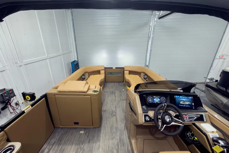 Slide: The Image of Luxurious 2026 Godfrey Sanpan 25' Tritoon interior with plush seating and modern dashboard. - 53