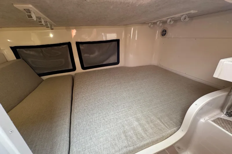 Slide: The Image of 2024 Grady-White Marlin 300 cabin interior with wooden flooring and carpeted steps. - 12