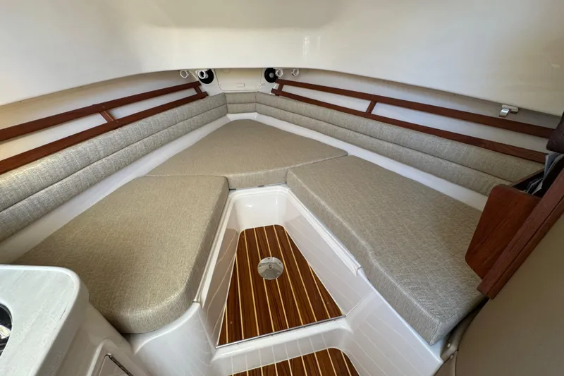 Slide: The Image of 2024 Grady-White Marlin 300 cabin interior with kitchenette and seating area. - 20
