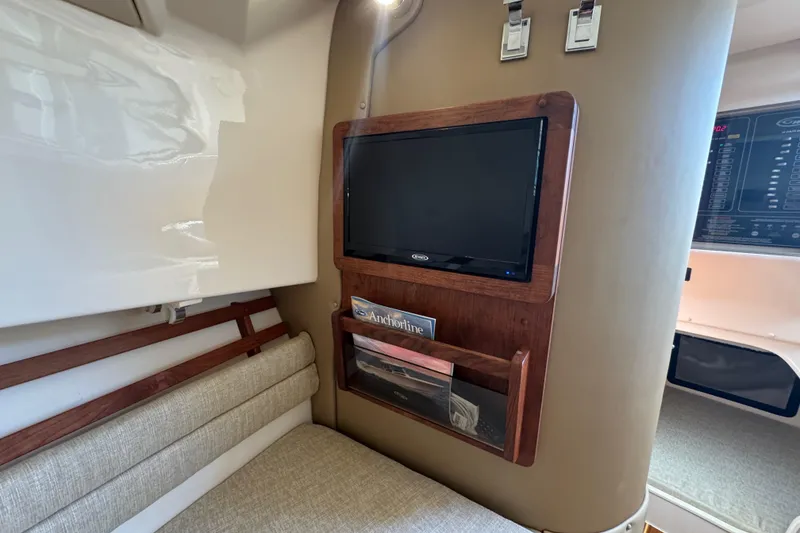 Slide: The Image of 2024 Grady-White Marlin 300 cabin interior with cushioned seating and wood accents. - 21