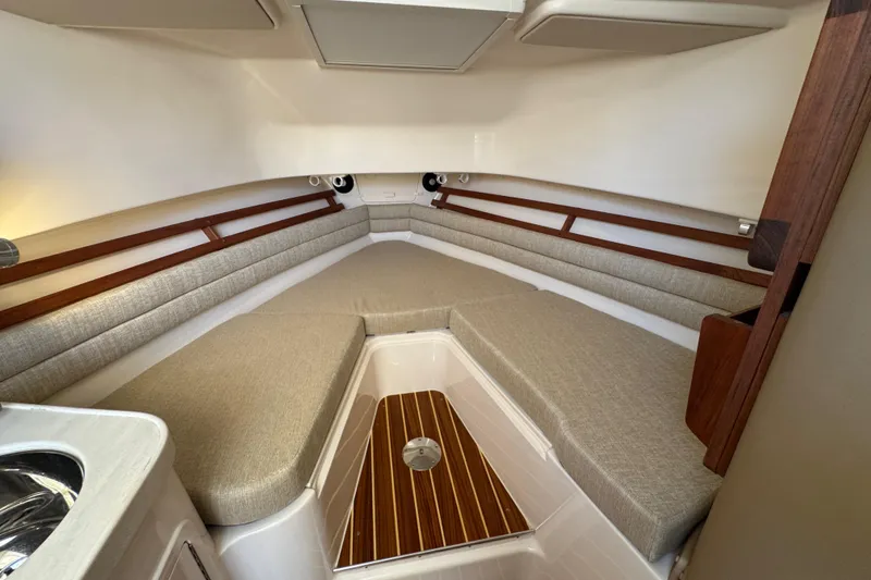 Slide: The Image of 2024 Grady-White Marlin 300 cabin interior with sink and cushioned seating. - 26