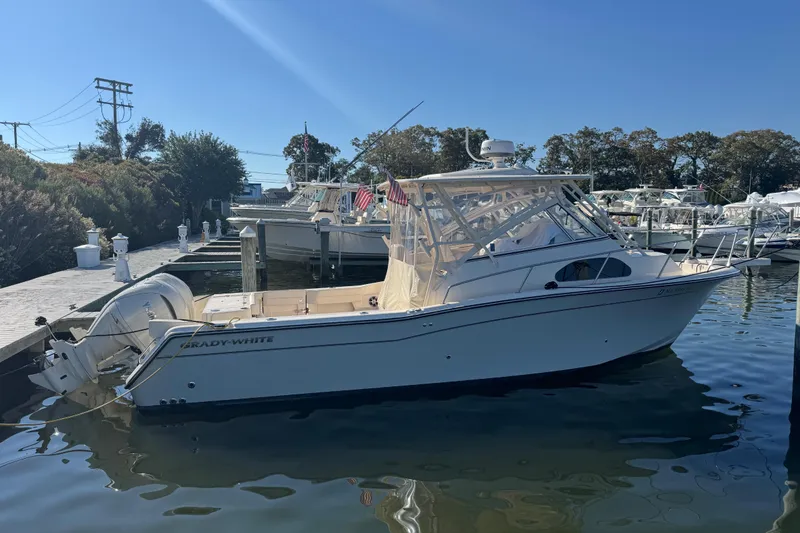 Slide: The Image of 2024 Grady-White Marlin 300 boat docked with twin 300 V6 engines. - 3