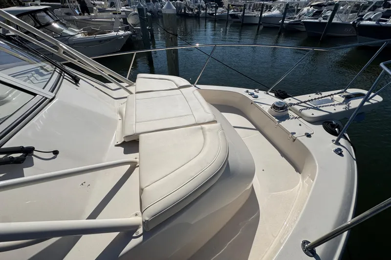 Slide: The Image of 2024 Grady-White Marlin 300 boat deck with cushioned seating and railing. - 30