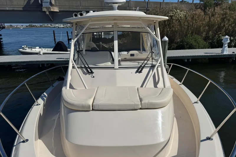 Slide: The Image of 2024 Grady-White Marlin 300 boat docked at marina, front view. - 32