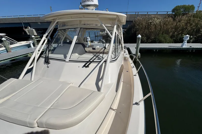 Slide: The Image of 2024 Grady-White Marlin 300 boat docked, featuring spacious deck and sleek design. - 33