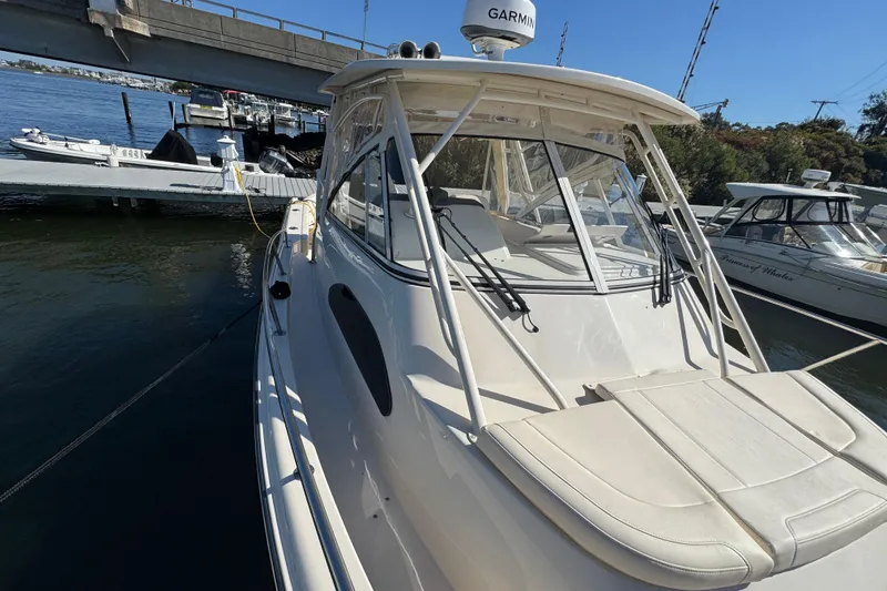 Slide: The Image of 2024 Grady-White Marlin 300 boat docked, featuring a sleek design and spacious deck. - 34