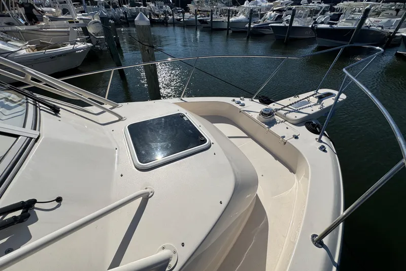Slide: The Image of 2024 Grady-White Marlin 300 boat docked, featuring Garmin equipment, under a bridge. - 36