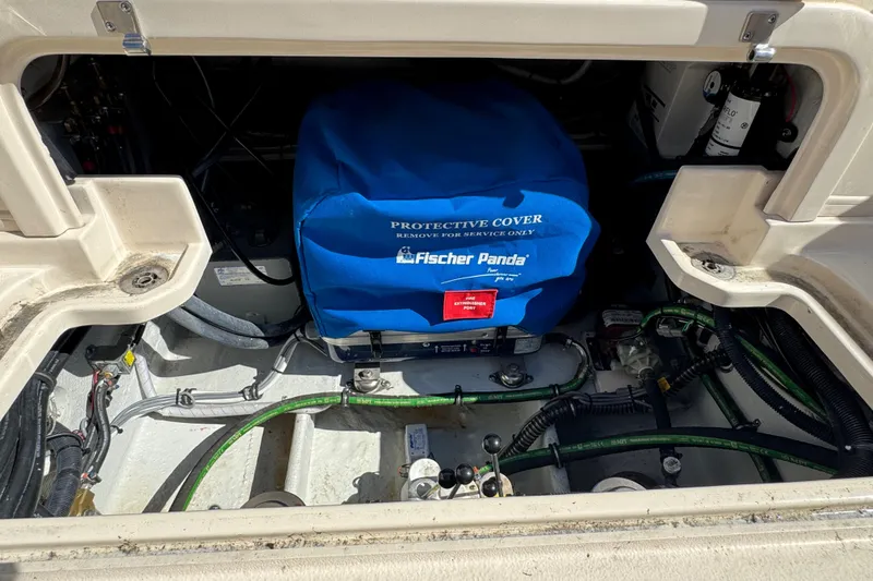 Slide: The Image of 2024 Grady-White Marlin 300 boat docked, showcasing open storage compartment and seating area. - 52