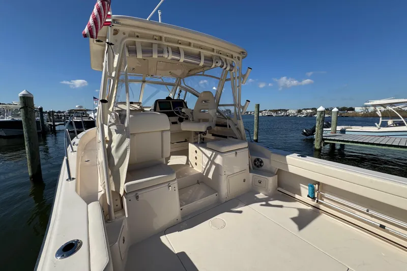 Slide: The Image of 2024 Grady-White Marlin 300 engine compartment with wiring and components. - 54