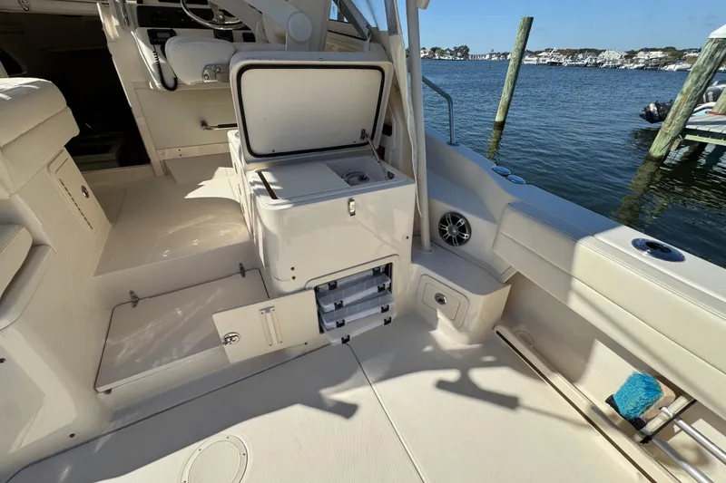 Slide: The Image of 2024 Grady-White Marlin 300 boat interior with open sink and storage compartments. - 59