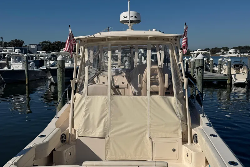 Slide: The Image of 2024 Grady-White Marlin 300 boat with twin Yamaha outboard engines docked at marina. - 6