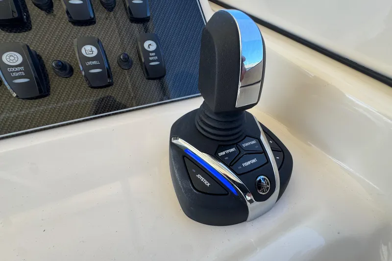 Slide: The Image of Bennett trim tab control on 2024 Grady-White Marlin 300 boat dashboard. - 70