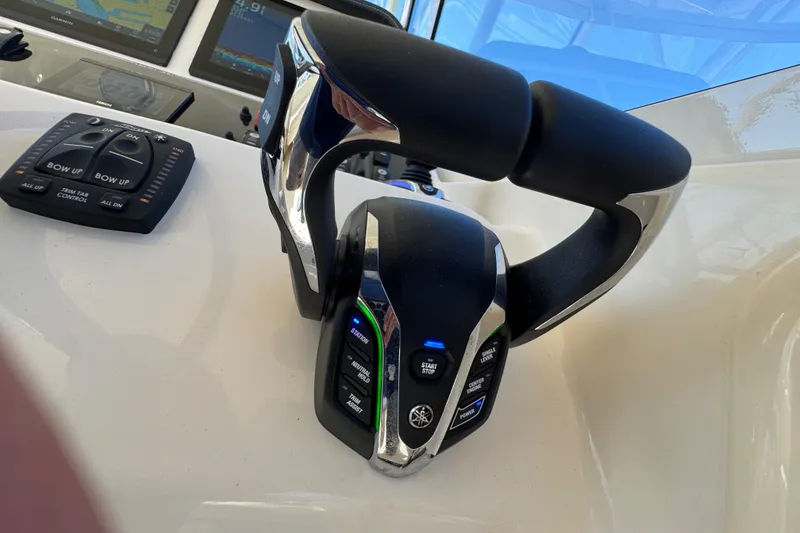 Slide: The Image of Joystick control panel on 2024 Grady-White Marlin 300 boat, featuring various function buttons. - 71