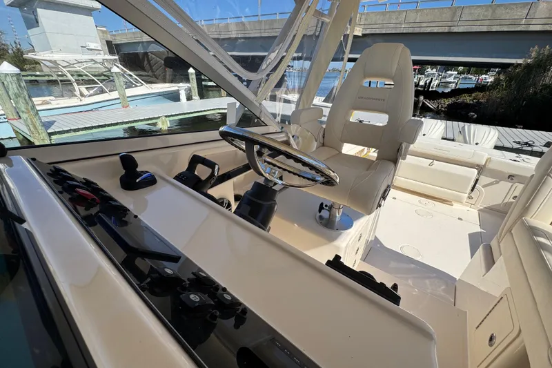 Slide: The Image of 2024 Grady-White Marlin 300 helm with luxurious seating and modern controls. - 76
