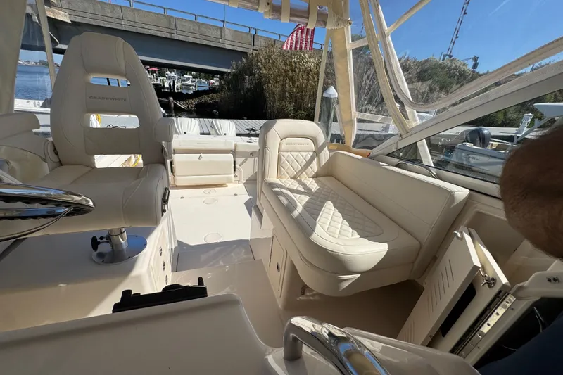 Slide: The Image of 2024 Grady-White Marlin 300 helm with steering wheel and captain's chair. - 77