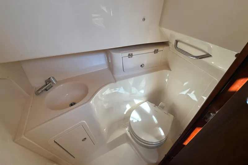 Slide: The Image of 2024 Grady-White Marlin 300 boat bathroom with dual sinks and modern fixtures. - 9
