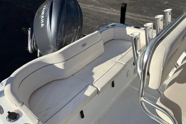Slide: The Image of 2025 Sea Hunt Ultra 219 boat interior with Yamaha engine, featuring cushioned seating and rod holders. - 13