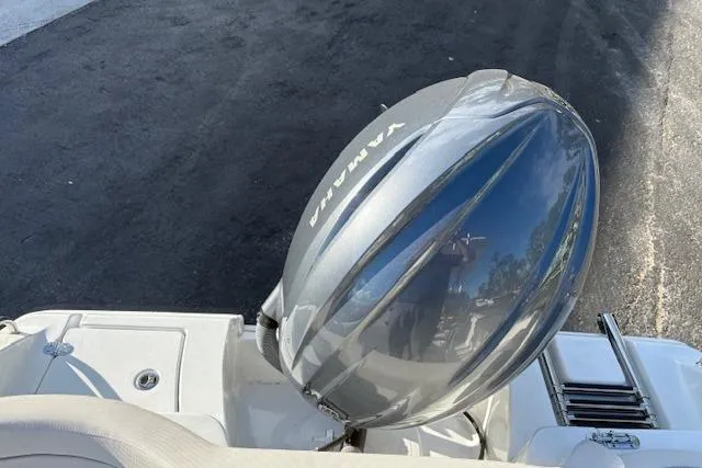 Slide: The Image of 2025 Sea Hunt Ultra 219 boat with Yamaha outboard motor, parked on asphalt. - 14