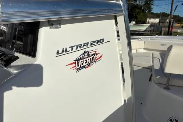 Slide: The Image of 2025 Sea Hunt Ultra 219 Liberty Edition boat, white interior, close-up view. - 17