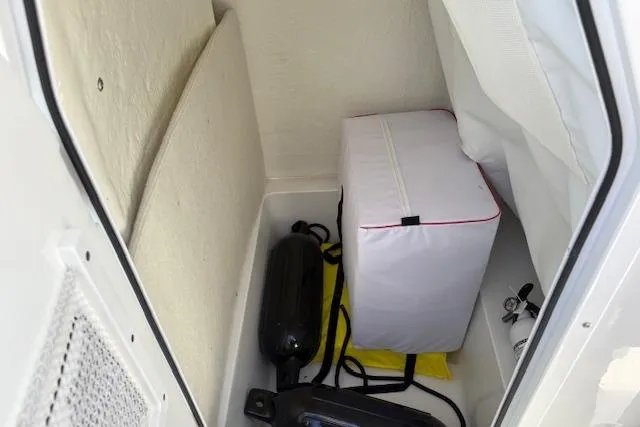 Slide: The Image of Storage compartment in a 2025 Sea Hunt Ultra 219 boat with equipment and accessories. - 19