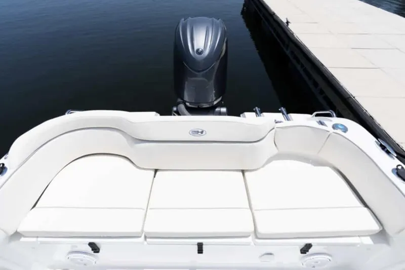 Slide: The Image of Manufacturer Provided Image: 2025 Sea Hunt Ultra 219 boat with cushioned seating and outboard motor at dock. - 26