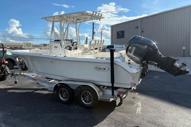Slide: The Image of 2025 Sea Hunt Ultra 219 boat on trailer, parked outdoors under a clear sky. - 4