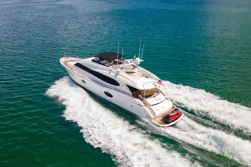 The Image of Luxurious 2008 Lazzara 84 Open Bridge yacht cruising on clear blue waters. - 1