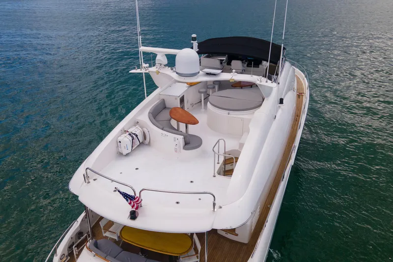 Slide: The Image of 2008 Lazzara 84 Open Bridge yacht on calm water, featuring spacious deck and seating area. - 10