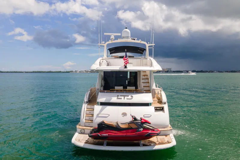 Slide: The Image of Luxury 2008 Lazzara 84 Open Bridge yacht with jet ski on calm waters. - 11