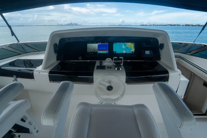 Slide: The Image of 2008 Lazzara 84 Open Bridge yacht helm with navigation screens and ocean view. - 18