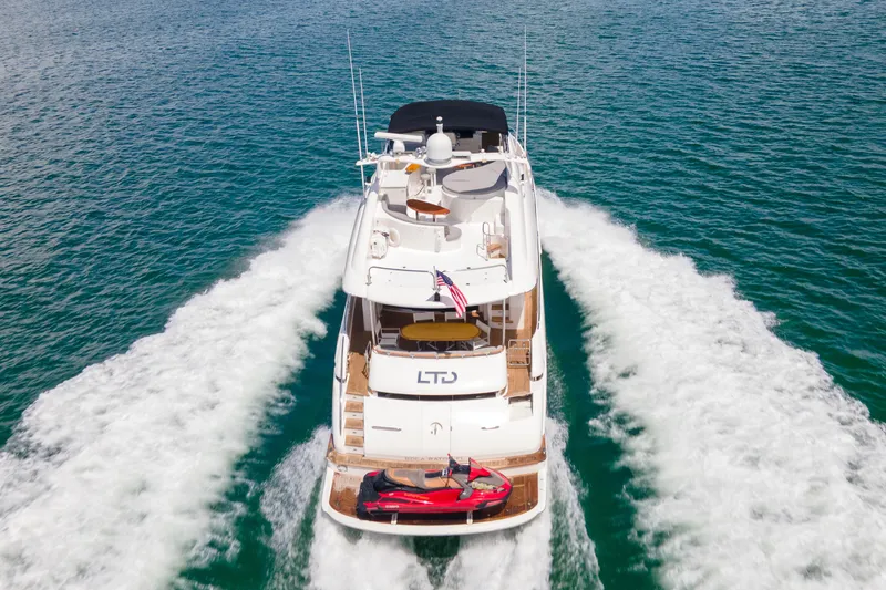 Slide: The Image of 2008 Lazzara 84 Open Bridge yacht cruising on open water, rear view. - 2