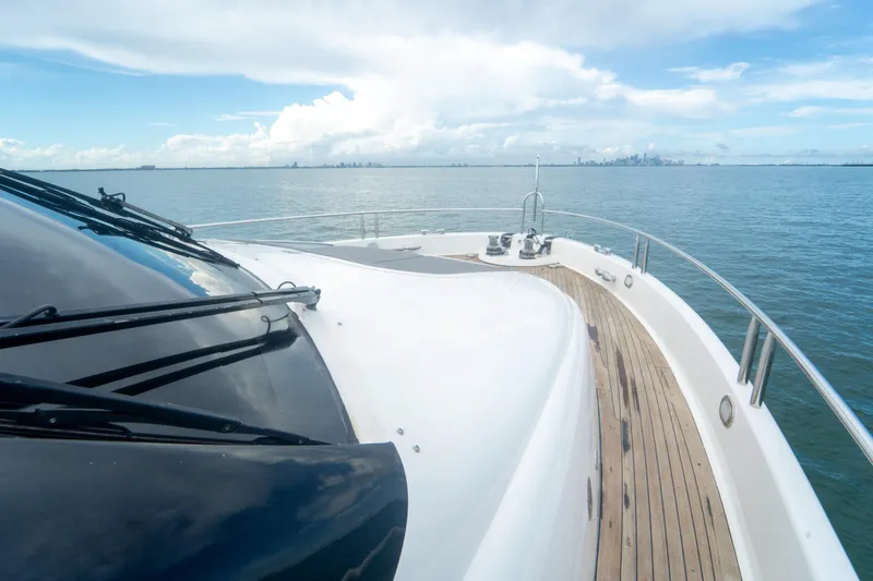 Slide: The Image of 2008 Lazzara 84 Open Bridge yacht cruising on calm waters with city skyline in background. - 24