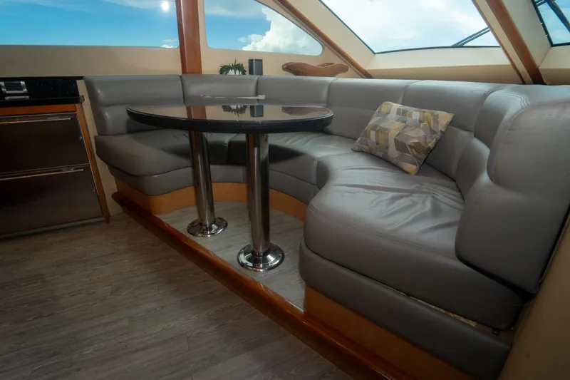 Slide: The Image of Luxurious interior of 2008 Lazzara 84 Open Bridge yacht with plush seating and table. - 33