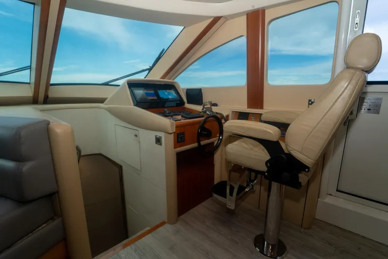 Slide: The Image of Luxurious helm of 2008 Lazzara 84 Open Bridge yacht with leather seating and navigation controls. - 35