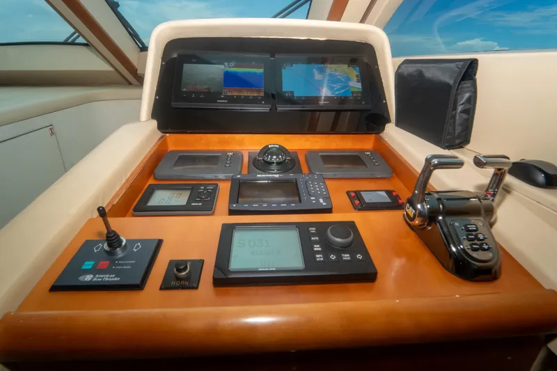 Slide: The Image of Control panel of 2008 Lazzara 84 Open Bridge yacht with navigation screens and controls. - 36