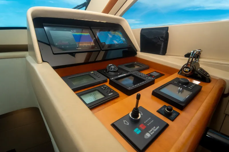 Slide: The Image of Control panel of 2008 Lazzara 84 Open Bridge yacht with navigation screens and controls. - 37