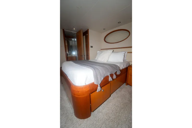 Slide: The Image of Luxurious bedroom interior on 2008 Lazzara 84 Open Bridge yacht, featuring elegant wood finishes. - 42