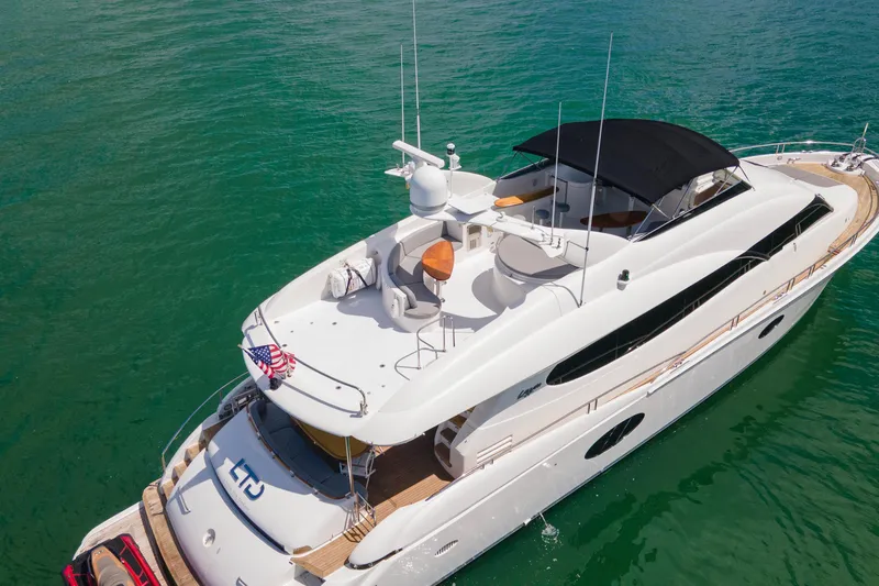 Slide: The Image of 2008 Lazzara 84 Open Bridge yacht on clear turquoise water, aerial view. - 9