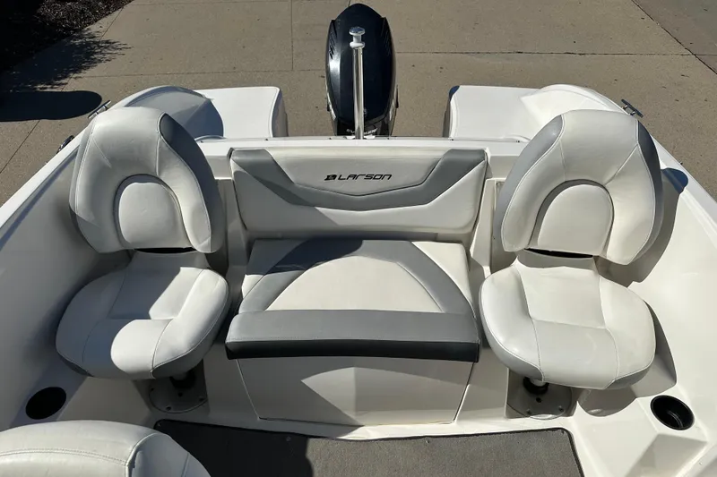 Slide: The Image of 2013 Larson LX 180S OB boat interior with white seating and outboard motor. - 11