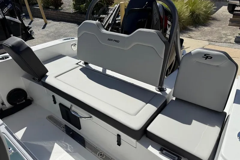 Slide: The Image of 2026 Sea Pro 245FLX Sandbar boat interior with cushioned seating and storage. - 13