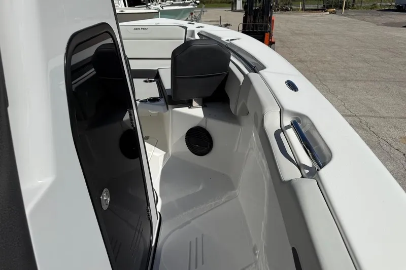 Slide: The Image of 2026 Sea Pro 245FLX Sandbar boat interior, featuring seating and storage compartments. - 18