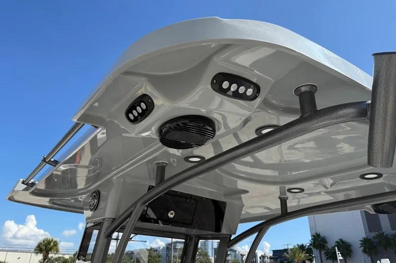 Slide: The Image of 2026 Sea Pro 245FLX Sandbar boat roof with integrated lights and speakers under clear blue sky. - 21