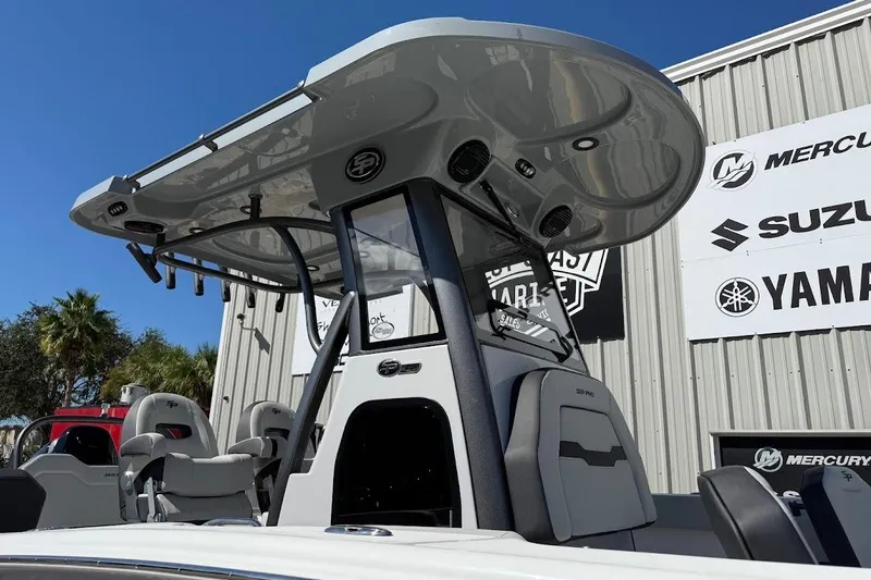 Slide: The Image of 2026 Sea Pro 245FLX Sandbar boat with T-top, displayed at a marine dealership. - 4
