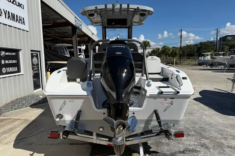 Slide: The Image of 2026 Sea Pro 245FLX Sandbar boat with powerful outboard motor, parked outdoors. - 6