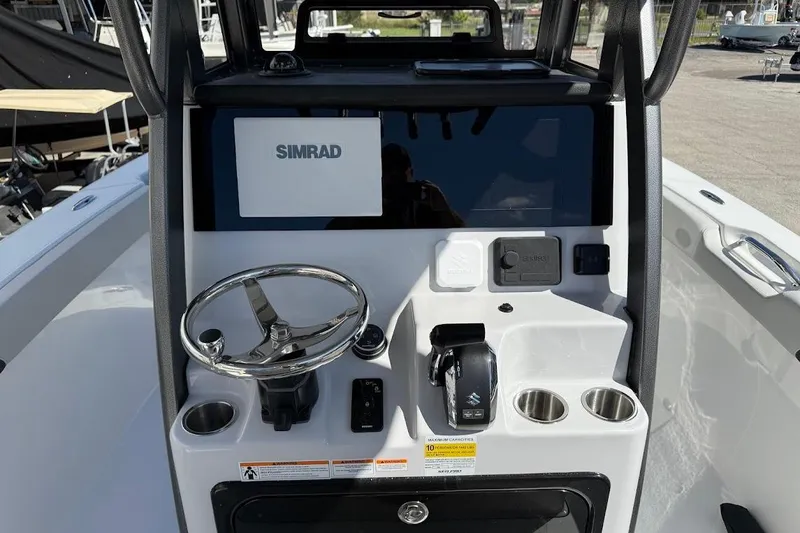 Slide: The Image of 2026 Sea Pro 245FLX Sandbar boat console with Simrad display and steering wheel. - 7