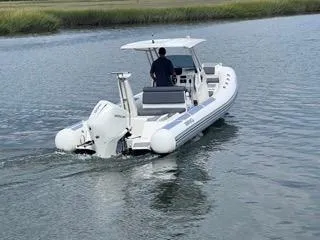 Slide: The Image of 2026 Brig Eagle 8 boat cruising on a calm river with a person steering. - 12