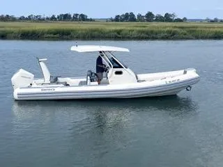 Slide: The Image of 2026 Brig Eagle 8 boat on calm water with canopy and outboard motor. - 17