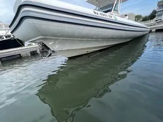 Slide: The Image of 2026 Brig Eagle 8 boat docked on calm water, side view. - 19